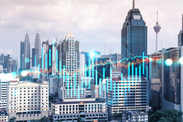 Forex and stock market chart hologram over panorama city view of Kuala Lumpur. KL is the financial center in Malaysia, Asia. The concept of international trading. Double exposure.