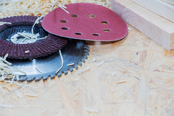 Carpenter tools on wooden table with sawdust. Circular Saw. Carpenter workplace top view.