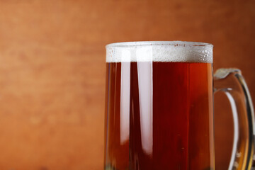 Glass of light beer with foam, shallow depth of field, space for text