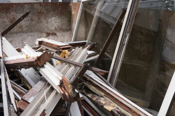 Container with fragments of old wooden windows, collected for recycling