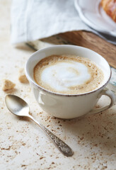 Coffee with milk on bright stone background. Close up.