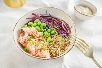 Poke bowl with couscous, baked salmon, bean, and cabbage. Healthy eating concept.