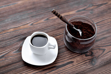 coffee in a cup on a stone stand, glass jar with coffee and a vintage coffee spoon, wooden natural...
