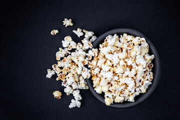 Obraz na płótnie Canvas Homemade Kettle Corn Popcorn on black background with copy space. Top view.