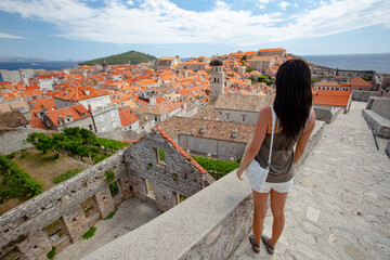 Fototapeta premium Brunette Girl on Walls of Old Town Dubrovnik, Medieval UNESCO Heritige Site, Croatia.