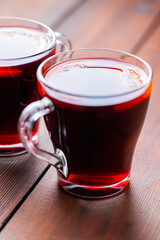 Mulled wine on wooden background. Winter drink traditional for the Christmas holidays. Two glasses of Christmas mulled wine with oranges