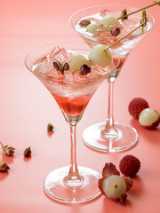 Sweet lychee liqueur on the pink background. Selective focus.
