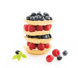 Mini tarts with berries isolated on a white background