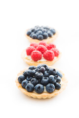 Mini tarts with berries isolated on a white background