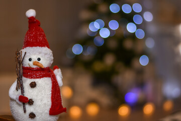 snowman in the Studio on the background of lights garlands