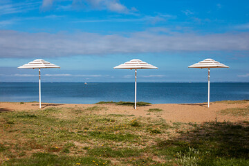 
city ​​beach with white parasols
