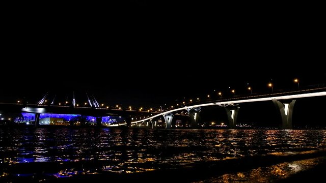 night view in 4K high-resolution video, view of the Gulf of Finland, yacht bridge, Zenit stadium with beautiful lighting and the ZSD Expressway