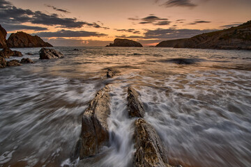 Landscape of an orange sunrise at Liencres beach	
