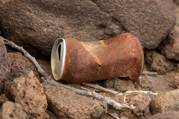 brown rusty drink can standing on the ground