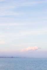 Cloud over coastline with apartments and port