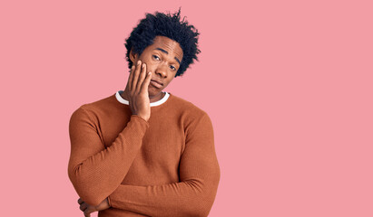 Fototapeta na wymiar Handsome african american man with afro hair wearing casual clothes thinking looking tired and bored with depression problems with crossed arms.