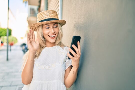 Young caucasian tourist girl doing video call using smartphone at city.