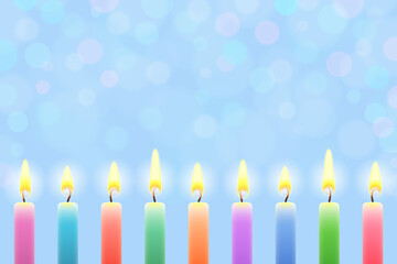 Light festive background with burning colored candles