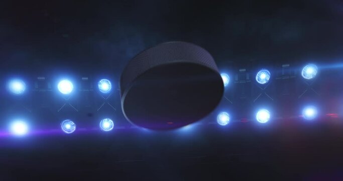 Flying ice hockey puck with flashing stadium spotlights in the night. Rotating sport ball. Sport 4k video background in endless loop.