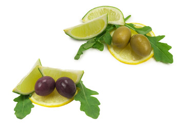 Two olives, piece of lemon and leaves of arugula isolated on white