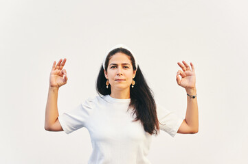 Portrait of woman showing mudrakhya on white background