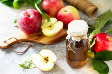 Naklejka na ściany i meble Apple vinegar. Healthy organic food. A bottle of apple cider vinegar on a light stone countertop.