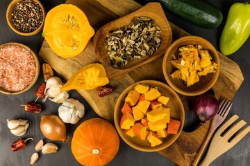 Sliced hokkaido pumpkin on a wooden board. Homemade preparation of pumpkin soup. Fresh vegetables. Healthy food.