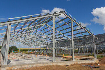 Steel frame of a building under construction. The construction of the building is made of steel beams. Construction of prefabricated structures