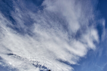 Cirrus clouds against a blue sky view from below