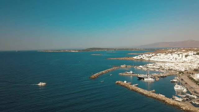 Aerial view of the pier with Paros island on a background Naousa village