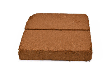 Natural coconut fibre soil pressed into brick shape isolated on white background