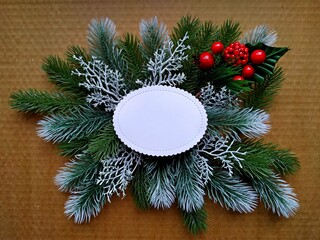 christmas background for postcard. Craft paper on fir branches with elements of Christmas decor