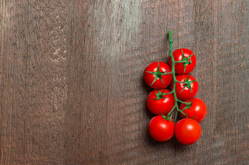 Cherry tomatoes on wooden background