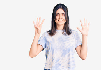 Young beautiful girl wearing casual t shirt showing and pointing up with fingers number nine while smiling confident and happy.