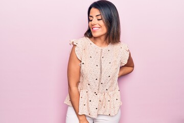 Obraz premium Young beautiful brunette woman wearing casual clothes smiling happy and confident. Standing with smile on face over isolated pink background