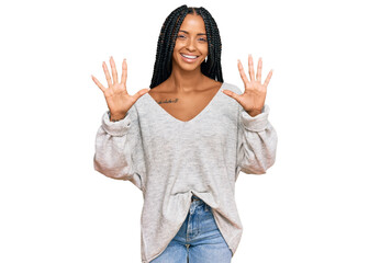 Beautiful hispanic woman wearing casual clothes showing and pointing up with fingers number ten while smiling confident and happy.