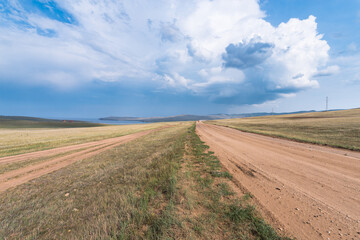 Fototapeta na wymiar Picturesque sky over the Maloye More Strait. Federal highway on the steppe coast of Olkhon Island.