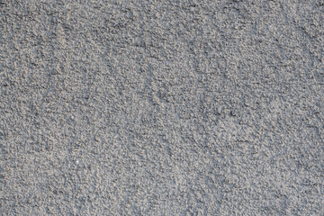 The texture of the gray wall. Decorative plaster.  Rough grainy bumpy surface. Perfect for background and design. Closeup.