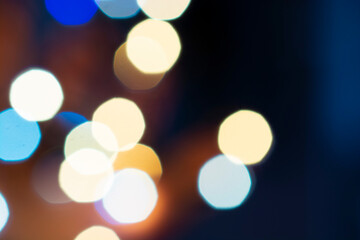 Fototapeta premium Christmas, New Year, holiday blurred background from lights garlands in the evening.