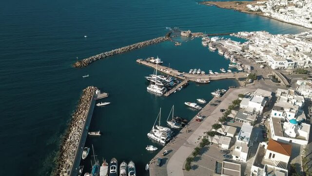 Aerial view of the pier with Paros island on a background Naousa village