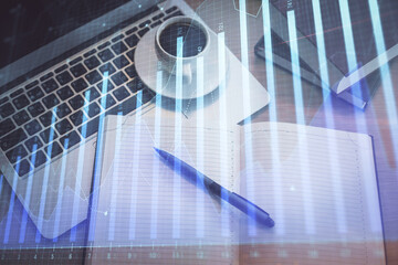 Fototapeta premium Stock market graph and top view computer on the table background. Multi exposure. Concept of financial education.