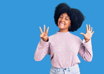 Young african american girl wearing casual clothes showing and pointing up with fingers number eight while smiling confident and happy.