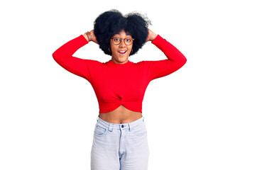 Young african american girl wearing casual clothes and glasses crazy and scared with hands on head, afraid and surprised of shock with open mouth
