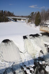 Beautiful Montmorency falls with snow in winter and the typical bridge, Quebec, Canada