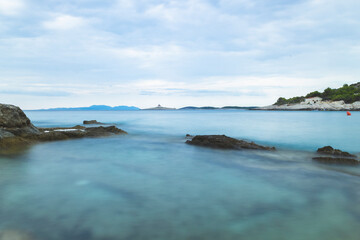 Fototapeta na wymiar Long exposure at one of beautiful Hvar island beaches with view on 