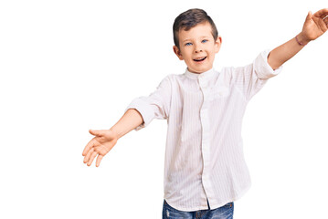 Cute blond kid wearing elegant shirt looking at the camera smiling with open arms for hug. cheerful expression embracing happiness.