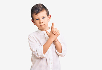 Cute blond kid wearing elegant shirt holding symbolic gun with hand gesture, playing killing shooting weapons, angry face