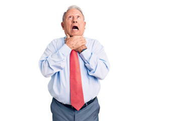 Senior handsome grey-haired man wearing elegant tie and shirt shouting and suffocate because painful strangle. health problem. asphyxiate and suicide concept.