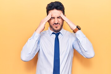 Young hispanic man wearing business clothes with hand on head, headache because stress. suffering migraine.