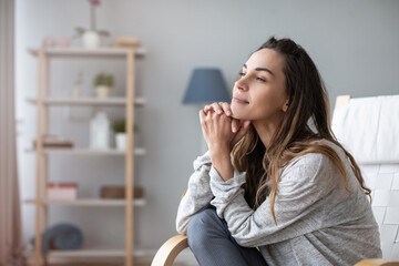 Woman relaxing in cozy chair at home. Female portrait.